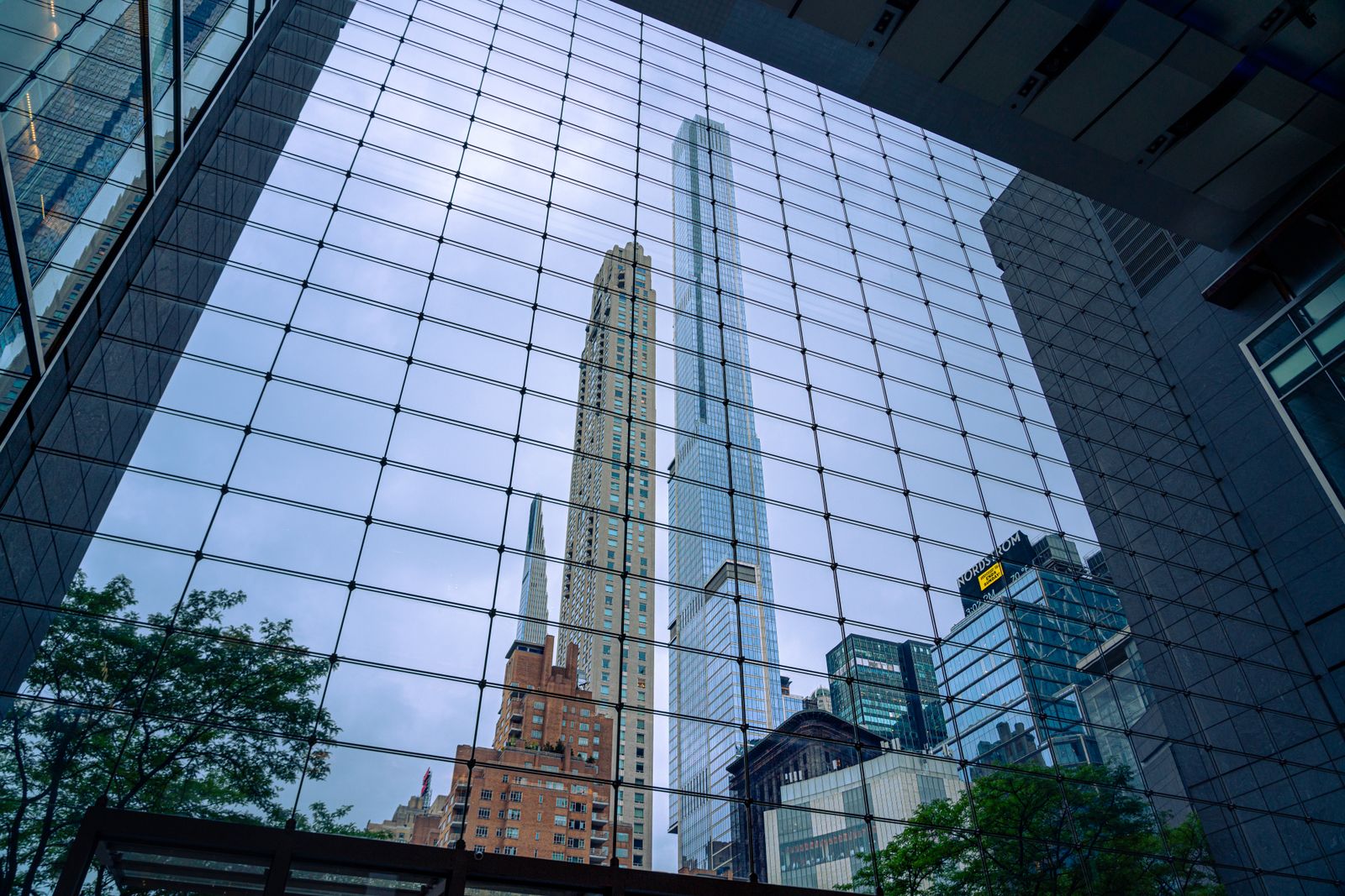 Manhattan towers framed by a glass facade.