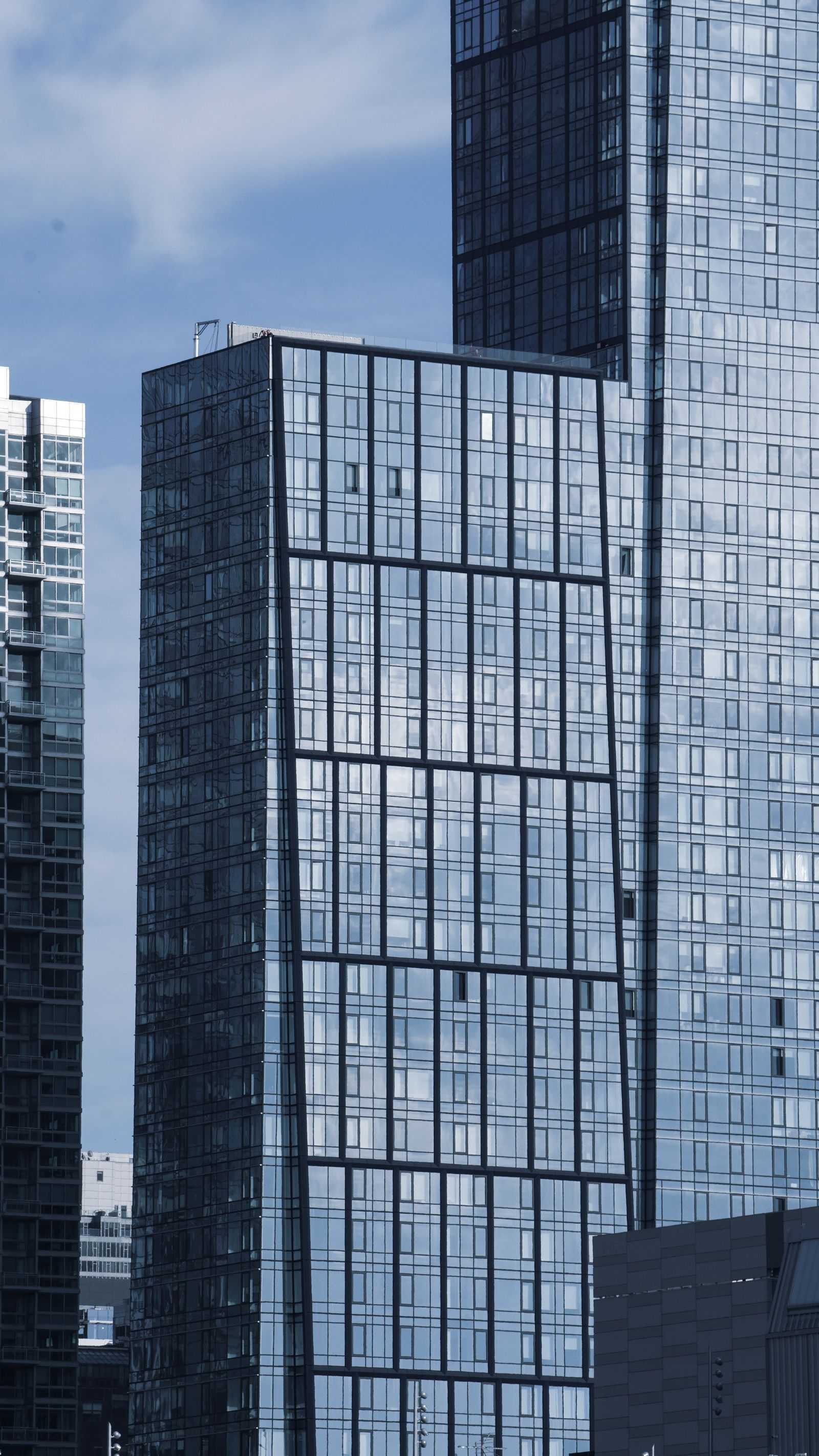 Glass towers with a geometric window pattern in Manhattan.