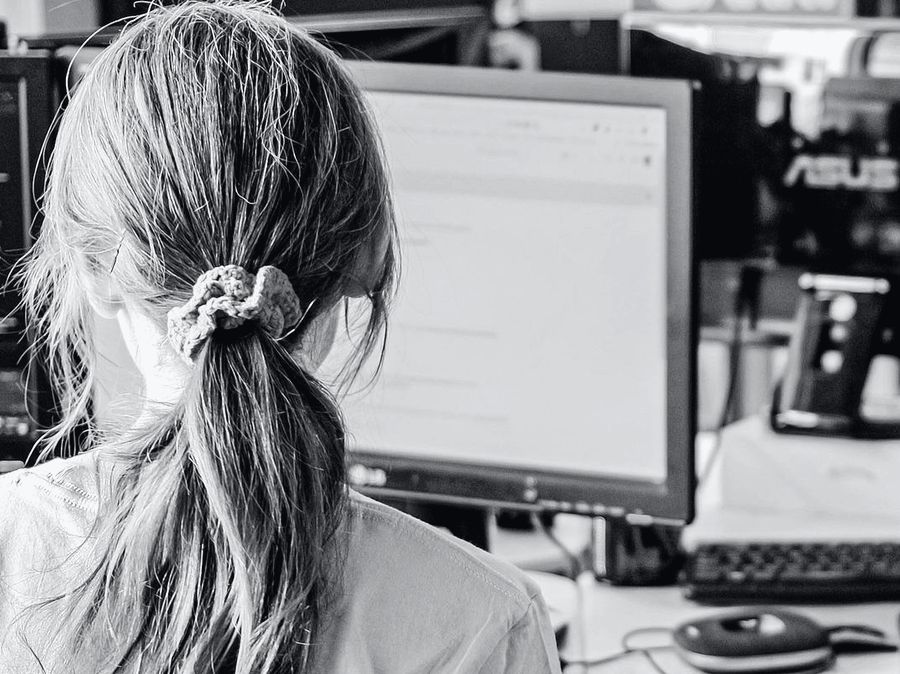 A software engineer at work on two screens.
