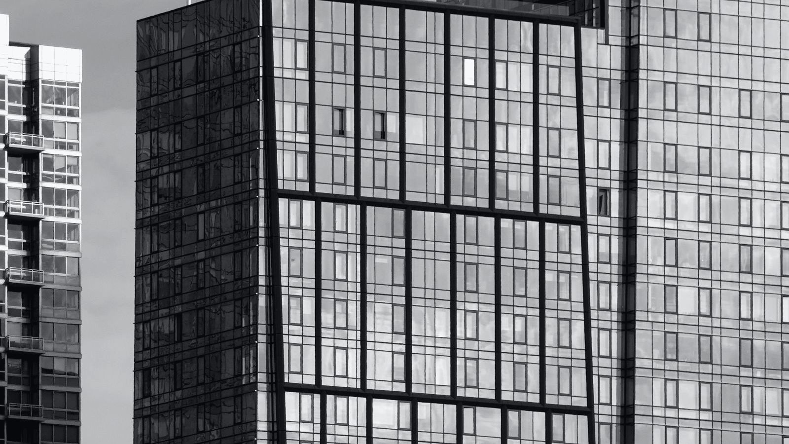 Glass towers seen from street level.