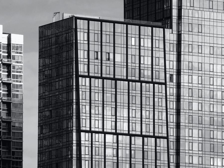 Glass towers seen from street level.