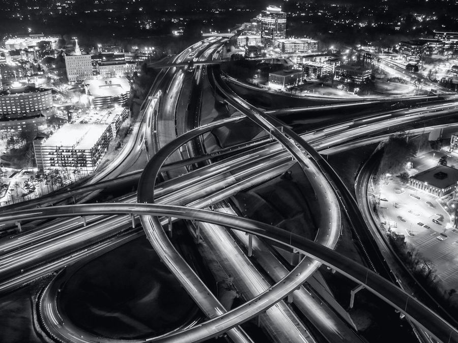 A highway interchange from above at night.