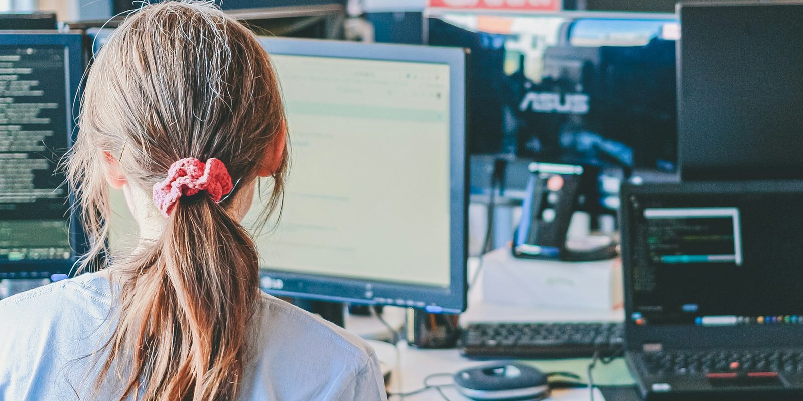 A software engineer at work on two screens.